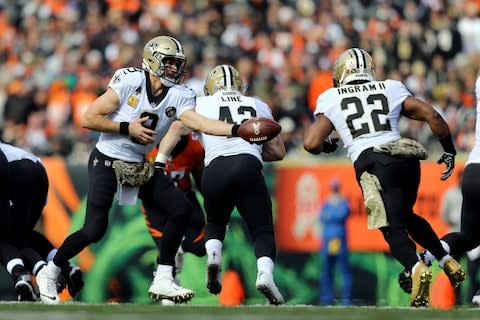 New Orleans Saints quarterback Drew Brees (9) hands the ball off to running back Mark Ingram (22) against the Cincinnati Bengals in the first half at Paul Brown Stadium - Credit: Aaron Doster/USA Today