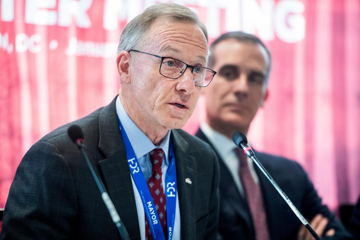 <span>John Giles, left, speaks at the conference of mayors in Washington DC on 22 January 2020.</span><span>Photograph: Tom Williams/CQ-Roll Call via Getty Images</span>