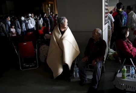 Evacuees wait for food supply inside the Joso City local interchange center known as Toyota Castle where hundreds of evacuees from an area flooded by the Kinugawa river, caused by typhoon Etau, were stuck here over night, in Joso, Ibaraki prefecture, Japan, September 11, 2015. REUTERS/Issei Kato