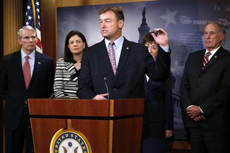 Senator Dean Heller (R-NV) (C), together with fellow Republicans U.S. Senator Rob Portman (R-OH) (L-R), Senator Kelly Ayotte (R-NH), Senator Susan Collins (R-ME), and Senator Dan Coats (R-IN) speak to reporters about their opposition to the Democratic majority's constraints on voting procedures on the proposed unemployment insurance legislation at the U.S. Capitol in Washington, January 14, 2014. REUTERS/Jonathan Ernst