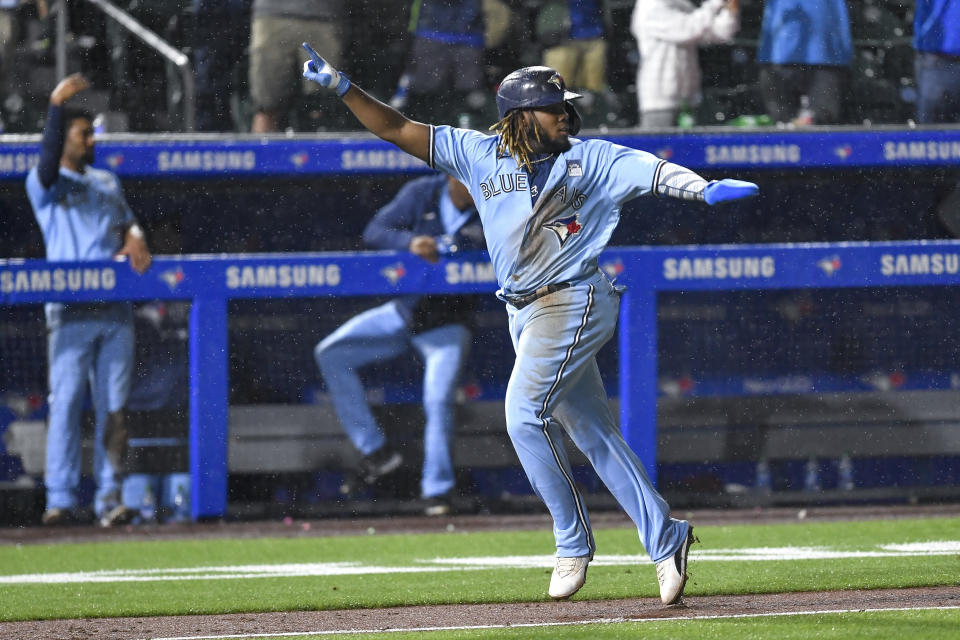 Toronto Blue Jays' Vladimir Guerrero Jr. (27) celebrates as he heads home to score the winning run as Miami Marlins center fielder Starling Marte made a fielding error on Joe Panik's fly ball during the ninth inning of a baseball game in Buffalo, N.Y., Wednesday, June 2, 2021. The Blue Jays won 6-5. (AP Photo/Adrian Kraus)