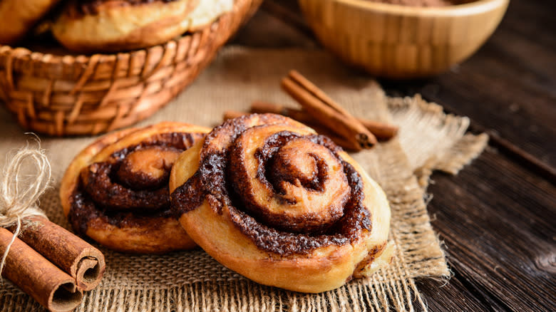 cinnamon sticks next to cinnamon rolls