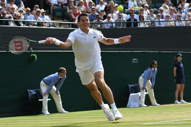 Canada's Milos Raonic returns to Sam Querrey of the US during their Wimbledon Championships men's singles quarter-final match, at The All England Lawn Tennis Club in south-west London, on July 6, 2016