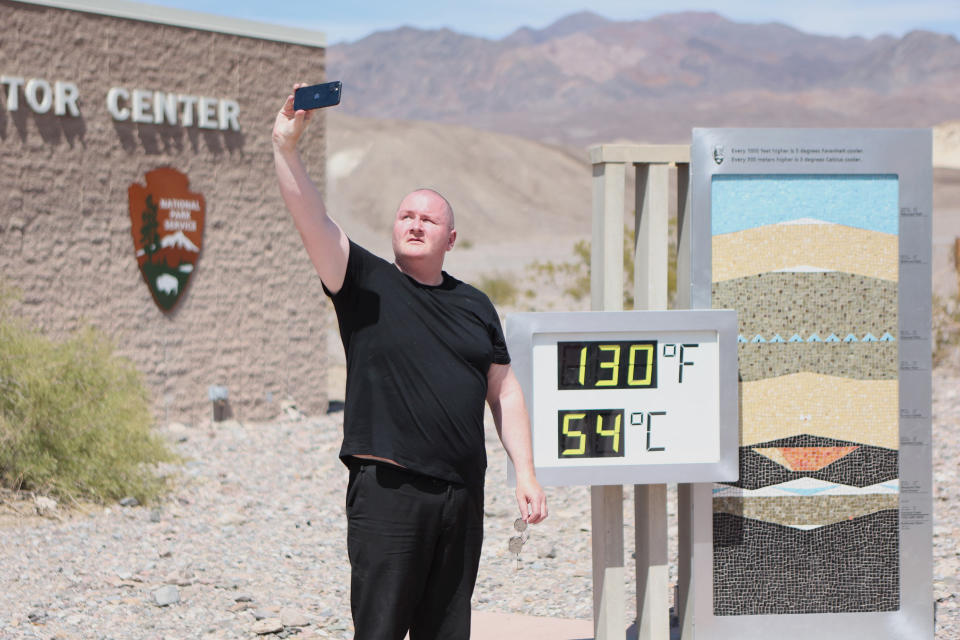 Scott Hughes, of Swansea, Wales, UK, takes a selfie next to a digital display of an unofficial heat reading at Furnace Creek Visitor Center during a heat wave in Death Valley National Park in Death Valley, California, on July 16, 2023. Tens of millions of Americans braced for more sweltering temperatures Sunday as brutal conditions threatened to break records due to a relentless heat dome that has baked parts of the country all week. By the afternoon of July 15, 2023, California's famous Death Valley, one of the hottest places on Earth, had reached a sizzling 124F (51C), with Sunday's peak predicted to soar as high as 129F (54C). Even overnight lows there could exceed 100F (38C). (Photo by Ronda Churchill / AFP) (Photo by RONDA CHURCHILL/AFP via Getty Images)
