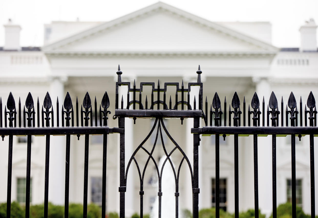 FILE - The White House is visible through the fence at the North Lawn in Washington. / Credit: Andrew Harnik / AP