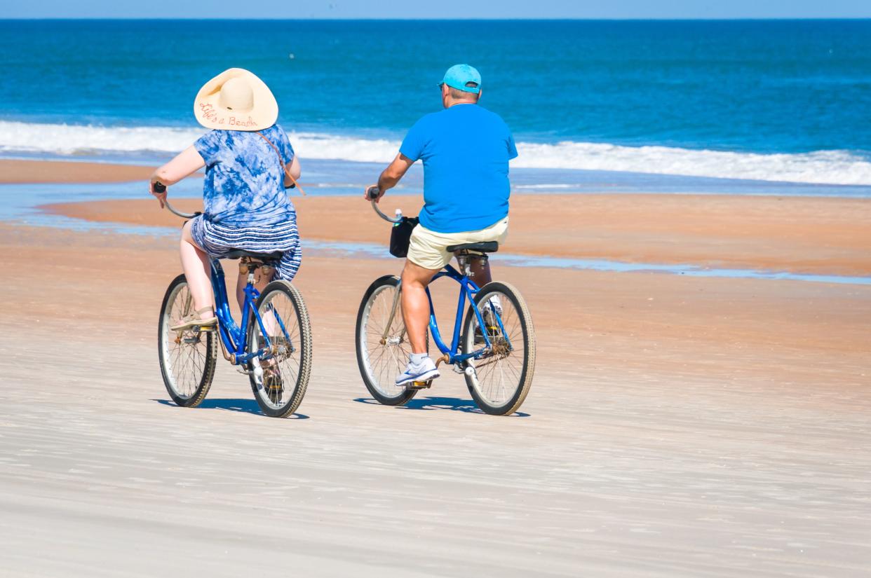 Daytona Beach, Florida, USA-December 29, 2021-A mature woman wearing a straw hat with the saying