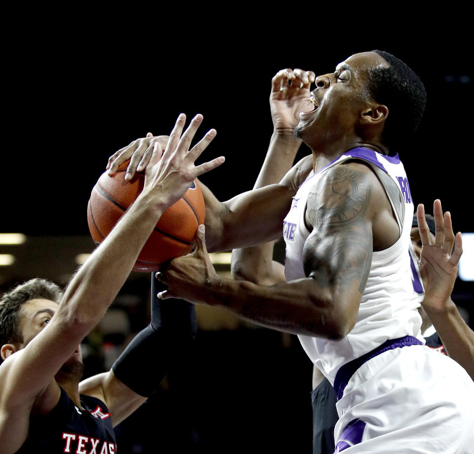Kansas State's Barry Brown Jr., right, shoots under pressure from Texas Tech's Davide Moretti during the second half of an NCAA college basketball game Tuesday, Jan. 22, 2019, in Manhattan, Kan. Kansas State won 58-45. (AP Photo/Charlie Riedel)