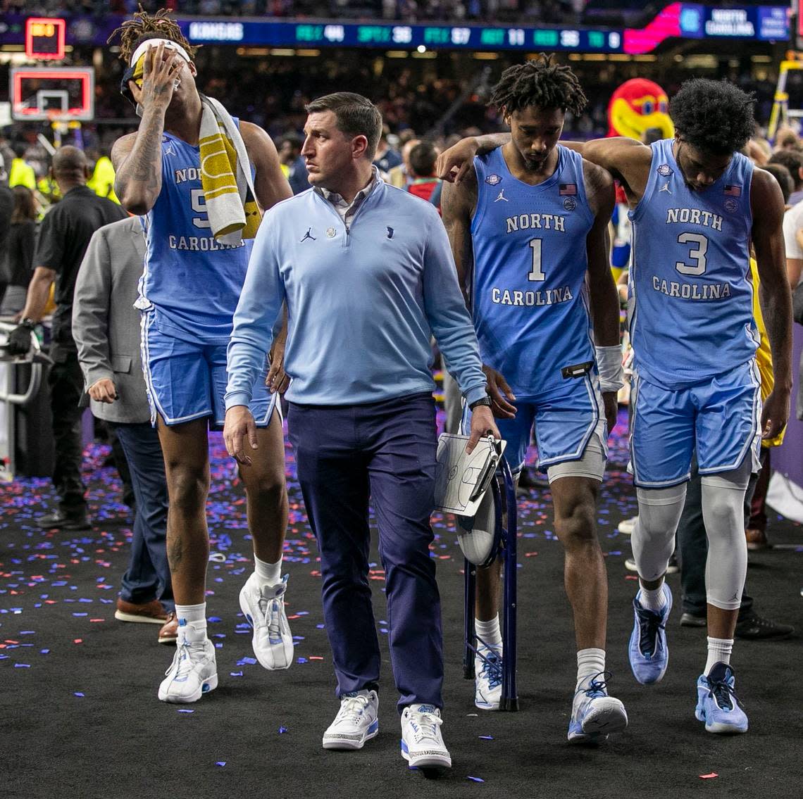 North Carolina’s Armando Bacot (5), in pain after a late game ankle injury, leaves the court with Eric Hoots, Leaky Black (1) and Dontrez Styles (3) following the the Tar Heels’ 72-69 loss to Kansas in the NCAA Championship game on Monday, April 4, 2022 at Caesars Superdome in New Orleans, La.