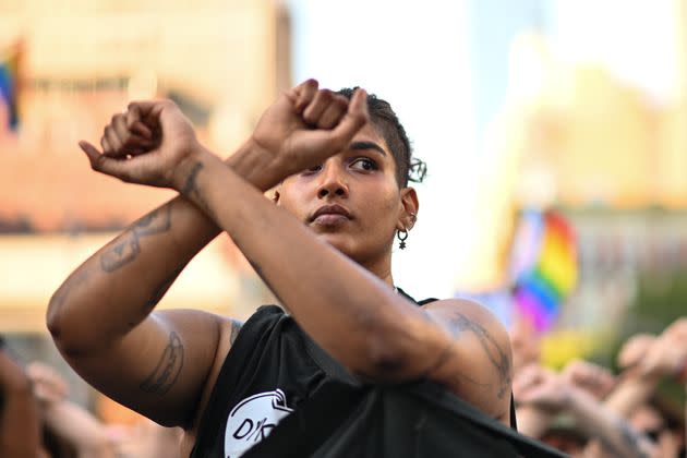 People stop for a moment of silence and raise their arms at the 30th Annual New York City Dyke March on June 25 in New York City. People also protested against the Supreme Court overturning the 50-year-old landmark Roe v. Wade decision ending federal abortion protection. (Photo: Alexi Rosenfeld via Getty Images)