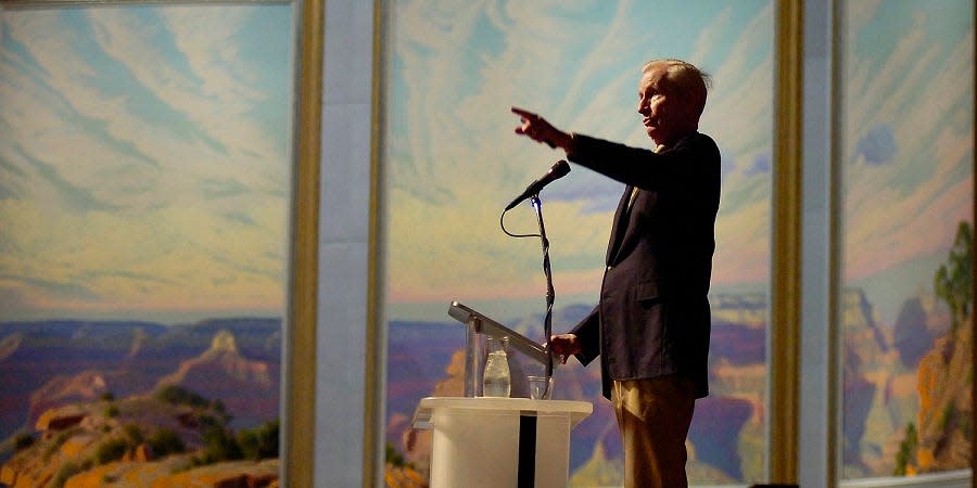 Acclaimed artist and Tulsa native Wilson Hurley speaks at the National Cowboy & Western Heritage Museum Friday, October 7, 2005, in Oklahoma City, Okla. In the background is his monumental triptych painting "Arizona Suite," which depicts the Grand Canyon. Hurley died in 2008.