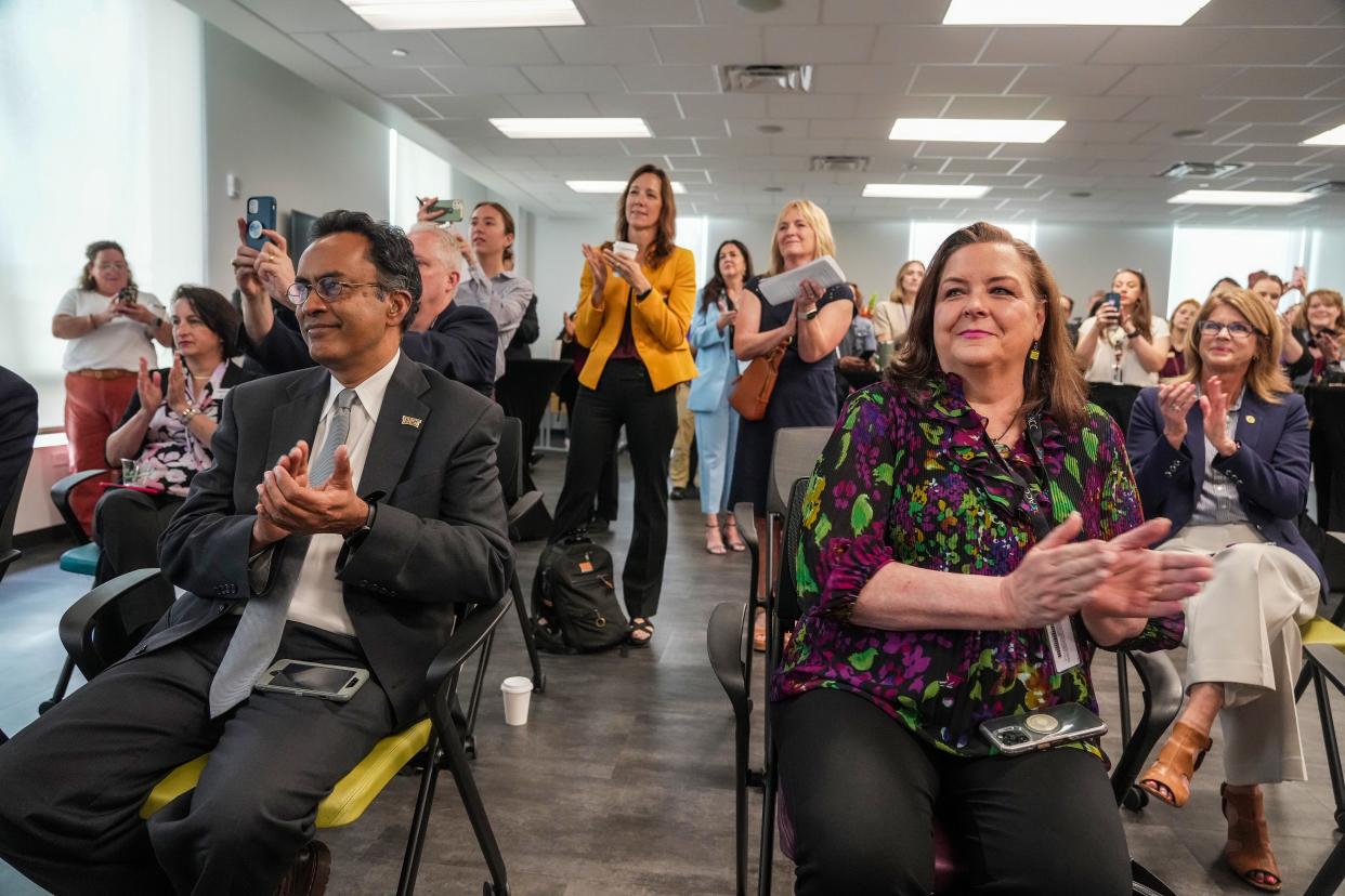 News conference attendees cheer as they get details of the new program, which will remove barriers to transferring for a bachelor's degree.
