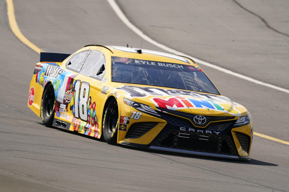 Kyle Busch (18) goes through turn one during a NASCAR Cup Series auto race at Pocono Raceway, Sunday, June 27, 2021, in Long Pond, Pa. Busch won the race. (AP Photo/Matt Slocum)