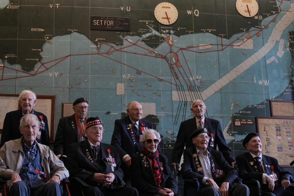 Normandy campaign veterans pose in the 'Map Room' which shows the large diagram of the D-Day invasion plans, at Southwick army base near Portsmouth, England, Monday, June 3, 2024. The map was used by Naval planners under the command of of British Admiral Bertram Ramsay. (AP Photo/Alastair Grant)