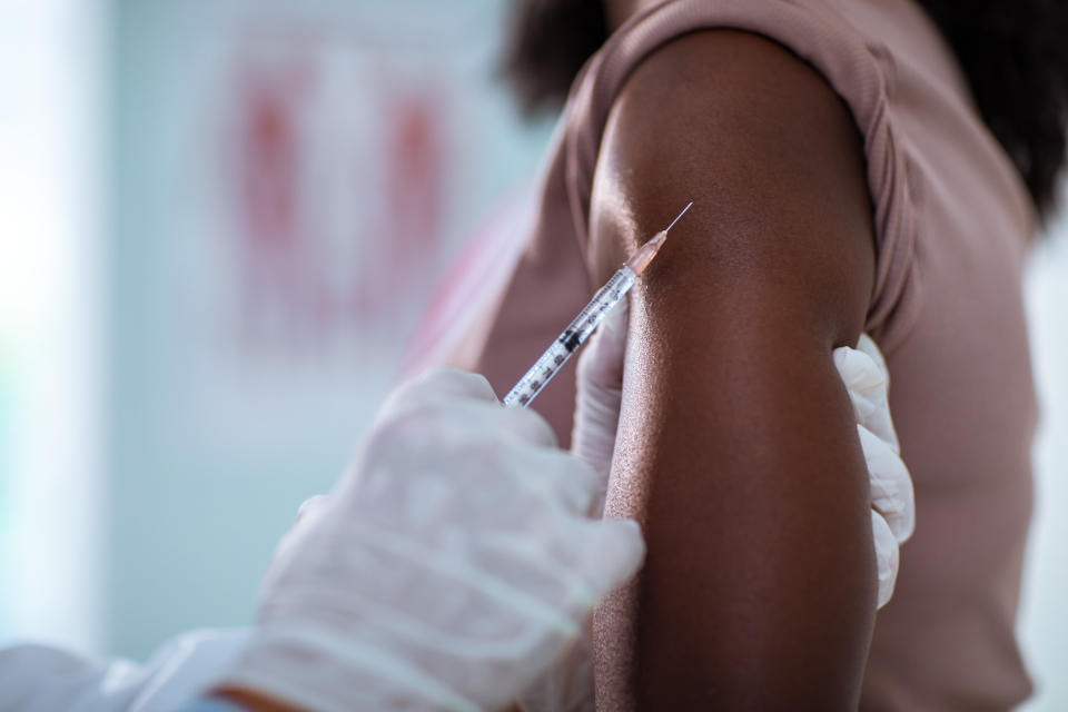 Close up of a young woman getting vaccinated