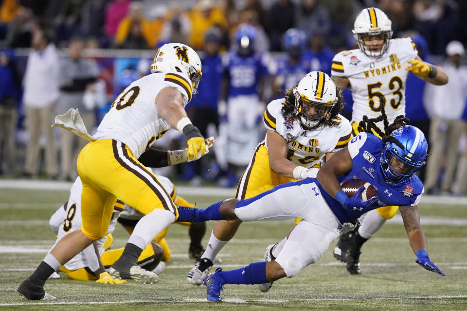 Georgia State running back Tra Barnett (5) dives for a first down against Wyoming during the second half of the Arizona Bowl NCAA college football game Tuesday, Dec. 31, 2019, in Tucson, Ariz. (AP Photo/Rick Scuteri)