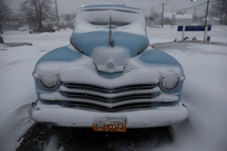 A car is seen covered in snow in Long Beach, New York. REUTERS/Shannon Stapleton