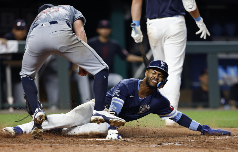 Cleveland Guardians pitcher Darren McCaughan, left, is late with the tag as Kansas City Royals' Maikel Garcia scores on a wild pitch during the eighth inning of a baseball game in Kansas City, Mo., Friday, June 28, 2024. (AP Photo/Colin E. Braley)