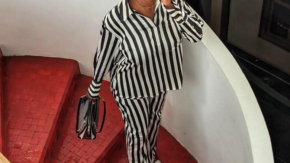 Yomi Adegoke wears a stripe twin set