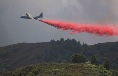 An air tanker drops fire retardant to slow the spread of the River Fire (Mendocino Complex) near Lakeport, California, U.S. August 1, 2018. REUTERS/Fred Greaves