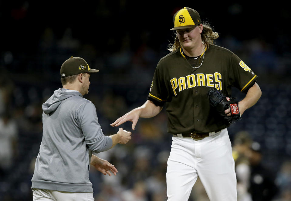 San Diego Padres relief pitcher Trey Wingenter, right, is removed by manager Andy Green during the eighth inning of the team's baseball game against the Arizona Diamondbacks in San Diego, Friday, Sept. 20, 2019. (AP Photo/Alex Gallardo)