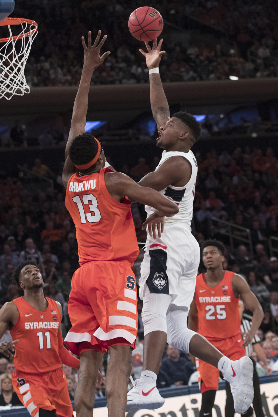 Connecticut forward Eric Cobb goes to the basket against Syracuse center Paschal Chukwu (13) during the second half of an NCAA college basketball game in the 2K Empire Classic, Thursday, Nov. 15, 2018, at Madison Square Garden in New York. Connecticut won 83-76. (AP Photo/Mary Altaffer)