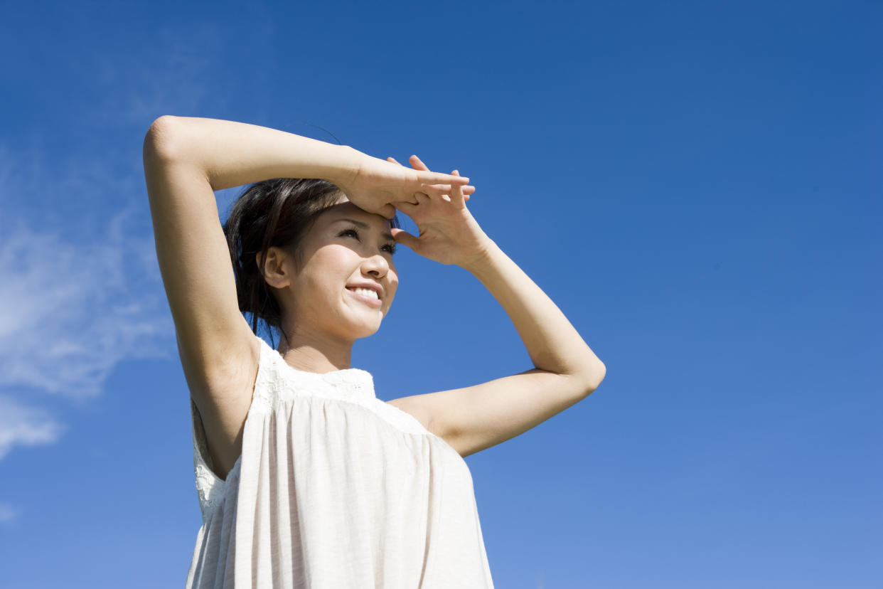 Stock photo of a young woman shielding her eyes. (PHOTO: Getty Images)