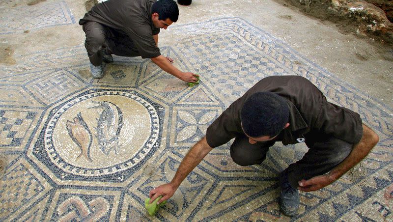 Prisoners work at a nearly 1,800-year-old decorated floor from an early Christian prayer hall discovered by Israeli archaeologists on Sunday, November 6, 2005 in the Megiddo prison. Israeli officials are considering uprooting the mosaic and loaning it to the controversial Museum of the Bible in Washington, D.C., a proposal that has upset archaeologists and underscores the hardline government’s close ties with evangelical Christians in the U.S.
