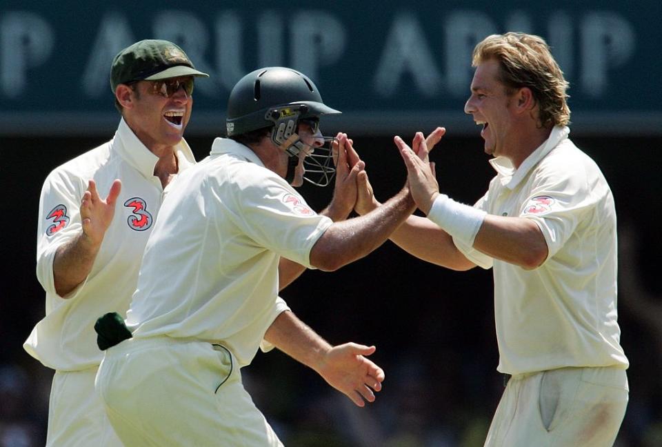 Shane Warne (R) of Australia is congratulated by team-mates Matthew Hayden (L) and Mike Hussey (C) after dismissing Alastair Cook of England at The Gabba on November 26, 2006 in Brisbane, Australia. (Photo by Jonathan Wood/Getty Images)