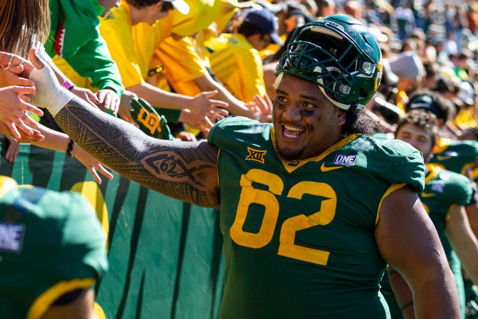 Baylor defensive tackle Siaki Ika celebrates with fans after a game against Texas on Oct. 30, 2021, in Waco.