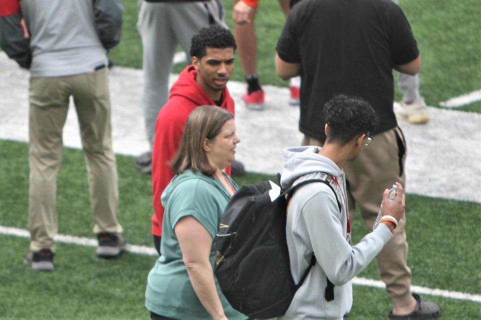 Daniel Freitag (in red jacket) checks out Wisconsin's football practice Saturday at Camp Randall Stadium. Freitag has scholarship offers from Wisconsin in both basketball and football.