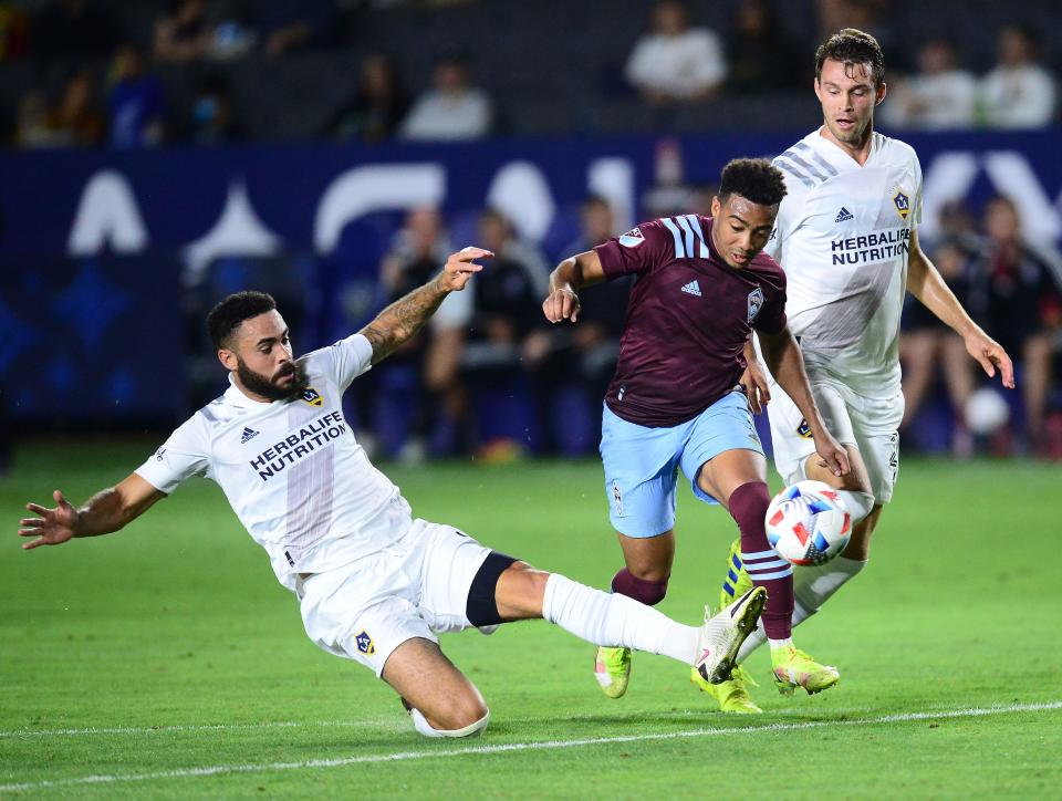 Los Angeles Galaxy defender Derrick Williams (left) moves in for the ball against the Colorado Rapids' Jonathan Lewis during the Rapids' 2-1 win on Aug. 17 at Dignity Health Sports Park.