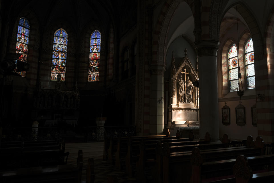 In this Thursday, April 9, 2020 photograph, the Sacred Heart Cathedral in Sarajevo, Bosnia, is deserted due to the national lockdown the authorities have imposed attempting to limit the spread of the new coronavirus. (AP Photo/Kemal Softic)