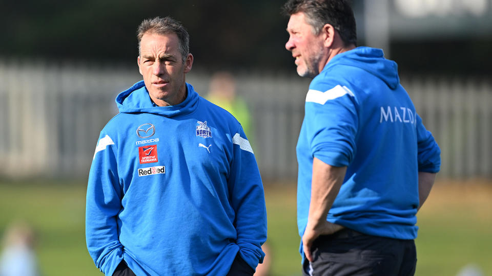 Alastair Clarkson is pictured with Brett Ratten in the foreground.