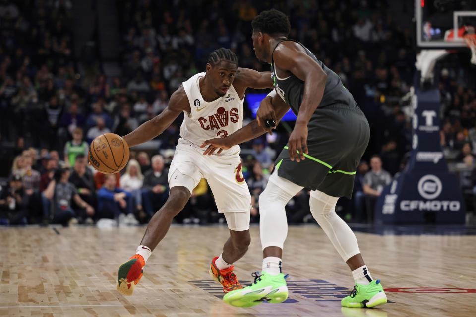 Cleveland Cavaliers guard Caris LeVert (3) handles the ball against Minnesota Timberwolves guard Anthony Edwards, right, during the second half of an NBA basketball game Saturday, Jan. 14, 2023, in Minneapolis. (AP Photo/Stacy Bengs)