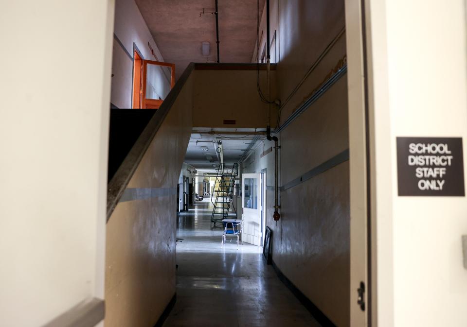 Silverton Middle School principal Brett Davisson opens a secured door to an abandoned part of the school. Parts of the building are not in use due to safety issues.