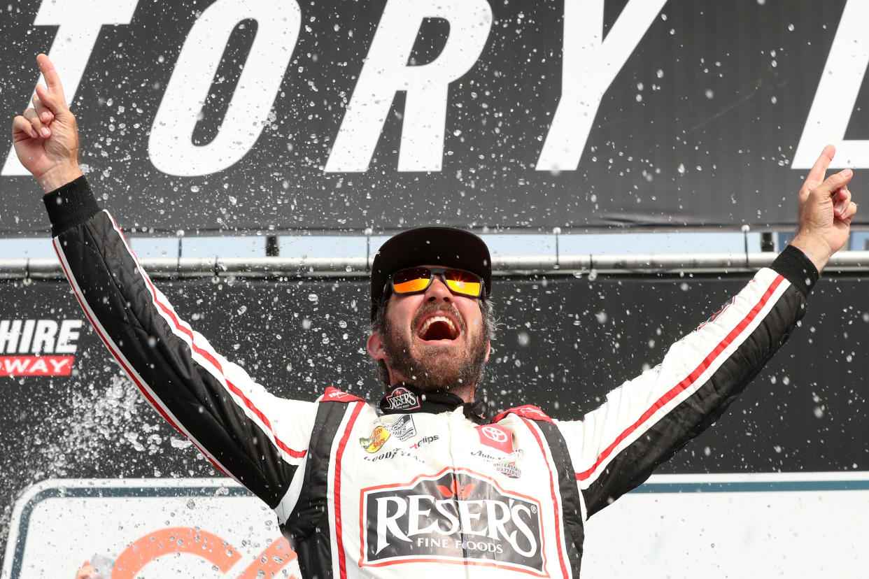 LOUDON, NEW HAMPSHIRE - JULY 17: Martin Truex Jr., driver of the #19 Reser's Fine Foods Toyota, celebrates in victory lane after winning the NASCAR Cup Series Crayon 301 at New Hampshire Motor Speedway on July 17, 2023 in Loudon, New Hampshire. (Photo by Meg Oliphant/Getty Images)