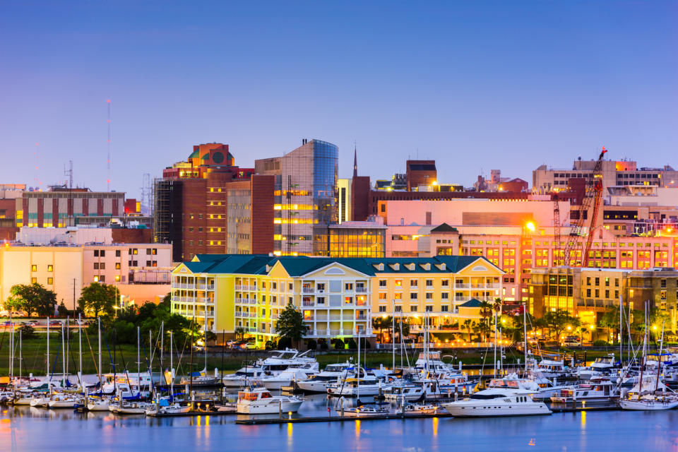 Charleston's historical waterfront in the backdrop of newer buildings, with cranes in the distance.