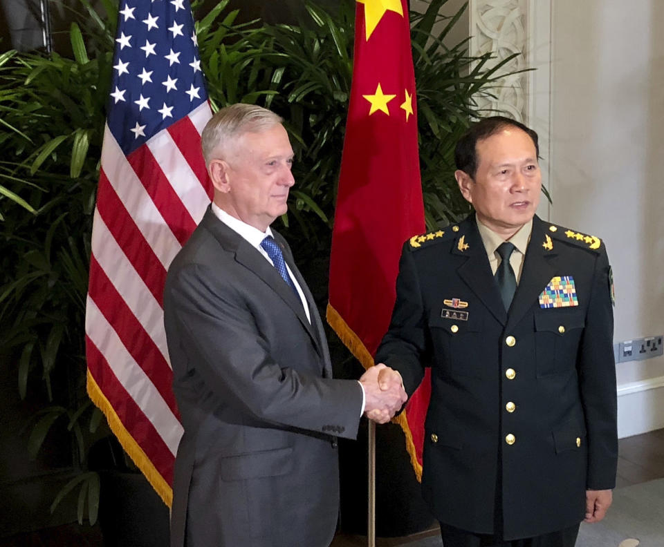 U.S. Defense Secretary Jim Mattis, left, meets Chinese Defense Minister Wei Fenghe in Singapore Thursday, Oct. 18, 2018. After a rocky few months, Pentagon officials say they sense that relations with the Chinese military may be stabilizing. (AP Photo/Robert Burns)