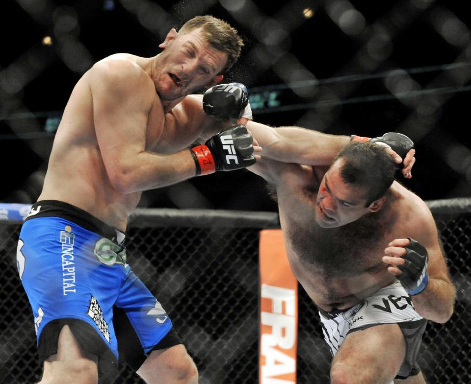 Stipe Miocic left, fights Gabriel Gonzaga right, during the heavyweight bout of a UFC mixed martial arts match in Chicago, Saturday, Jan. 25, 2014. (AP Photo/Paul Beaty)