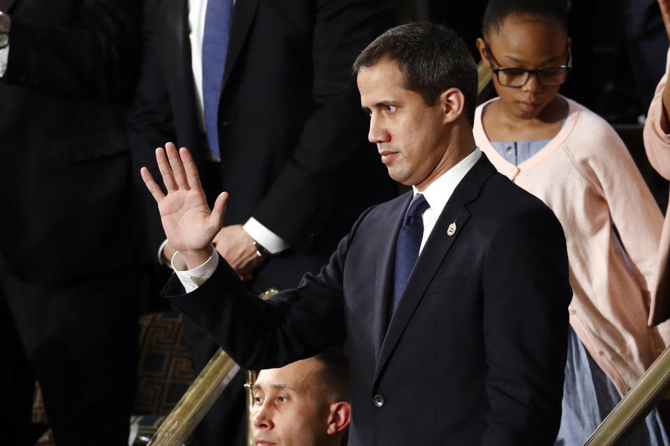 Venezuelan opposition leader Juan Guaido waves as President Donald Trump delivers his State of the Union address to a joint session of Congress on Capitol Hill in Washington, Tuesday, Feb. 4, 2020. (AP Photo/Patrick Semansky)