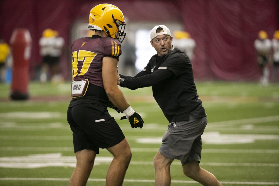 ASU interim tight end coach Juston Wood coaches alongside ASU tight end John Stivers during an ASU football practice at the Kajikawa Practice Facility in Tempe on August 16, 2021.