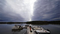 An oysterman drags a tray of adult "Uglie" oysters from Maine to awaiting oyster boats at Great Bay, Monday, May 3, 2021, in Durham, N.H. Thousands of Uglies from Maine, which were left to grow due to lack of retail demand of more than a year because of the virus outbreak, were relocated to Great Bay to enhance the shellfish species in New Hampshire coastal waters. (AP Photo/Charles Krupa)