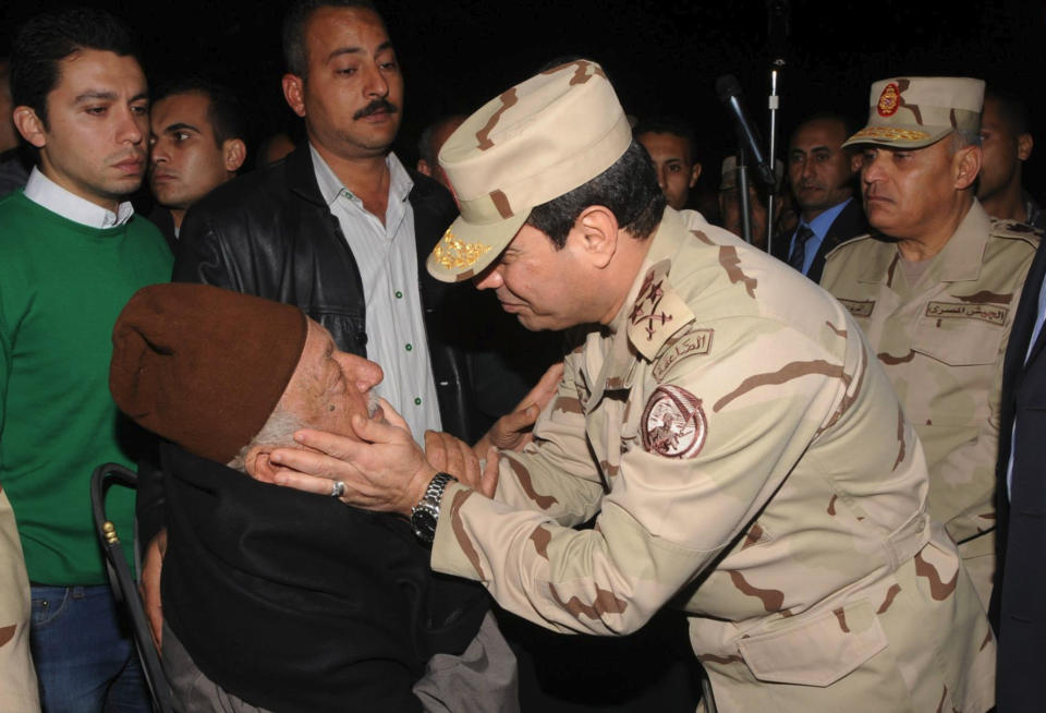 In this undated photo released by the Egyptian Defense Ministry, Defense Minister Gen. Abdel-Fattah el-Sissi consoles a man at a funeral for several military personnel who were killed when a helicopter crashed in the Sinai Peninsula, at an undisclosed location in Egypt. Egypt's military spokesman, Col. Ahmed Mohammed Ali said that an Air Force helicopter crashed near the village of el-Kharouba in the northern Sinai Peninsula early Saturday, where troops are battling Islamic militants. An al-Qaida-inspired group based in the Sinai Peninsula has claimed responsibility for bringing down an Egyptian military helicopter in the lawless desert region. (AP Photo/Egyptian Defense Ministry via Facebook)