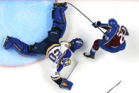 St. Louis Blues goaltender Jordan Binnington (50) blocks a shot by Colorado Avalanche center Nathan MacKinnon (29) during the third period in Game 2 of an NHL hockey Stanley Cup second-round playoff series Thursday, May 19, 2022, in Denver. The Blues won 4-1. (AP Photo/Jack Dempsey)