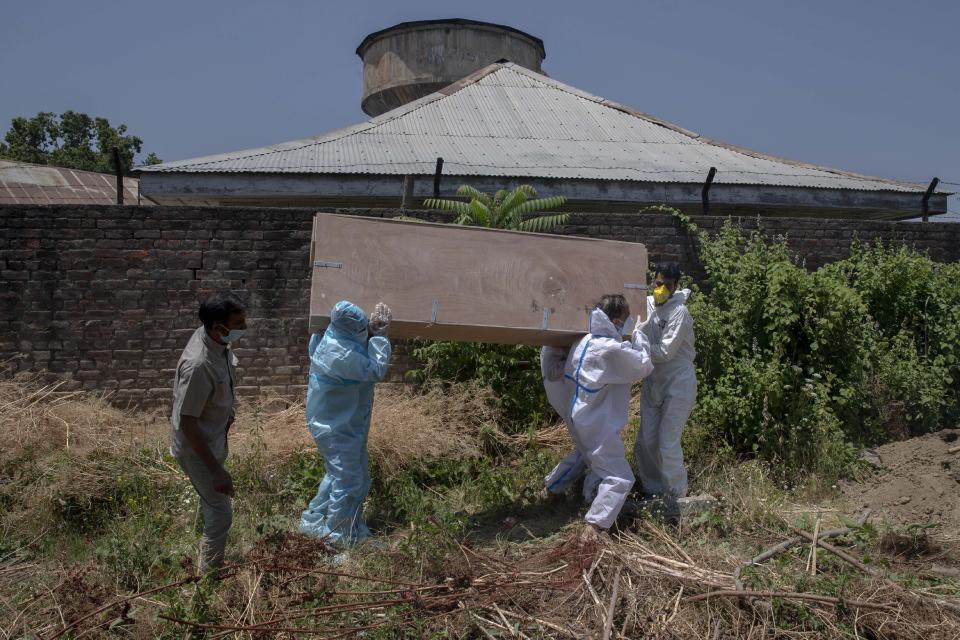 Relatives carry the body of a Kashmiri man who died of COVID-19 for burial at a cemetery in Srinagar, Indian controlled Kashmir, Friday, July 10, 2020. India has overtaken Russia to become the third worst-affected nation by the coronavirus pandemic. (AP Photo/ Dar Yasin)