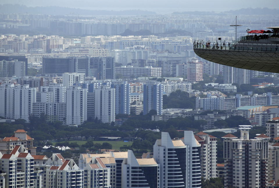 People look out from the observation tower of the Marina Bay Sands. (Photo:. REUTERS/Edgar Su)