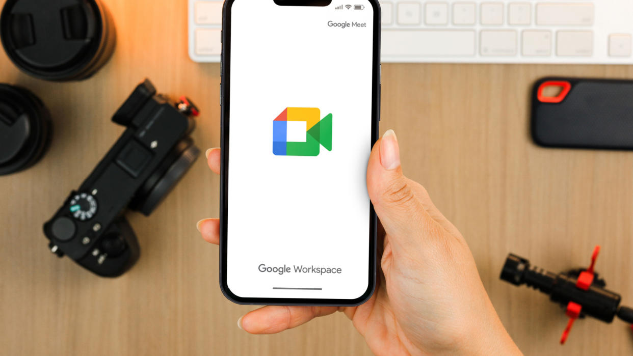  hand holding a phone with google workspace on the screen 