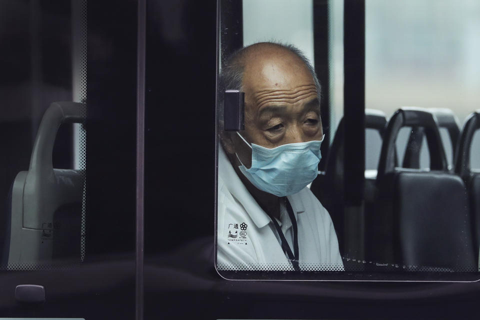 A man wearing a face mask to protect against the new coronavirus rides alone on a bus in Beijing, Tuesday, July 28, 2020. New coronavirus cases continue to rise in China's northwestern region of Xinjiang, with more than dozens reported on Tuesday. The capital Beijing also reported its first case of domestic transmission in more than two weeks, while the northeastern province of Liaoning added another several cases in its local outbreak. (AP Photo/Andy Wong)