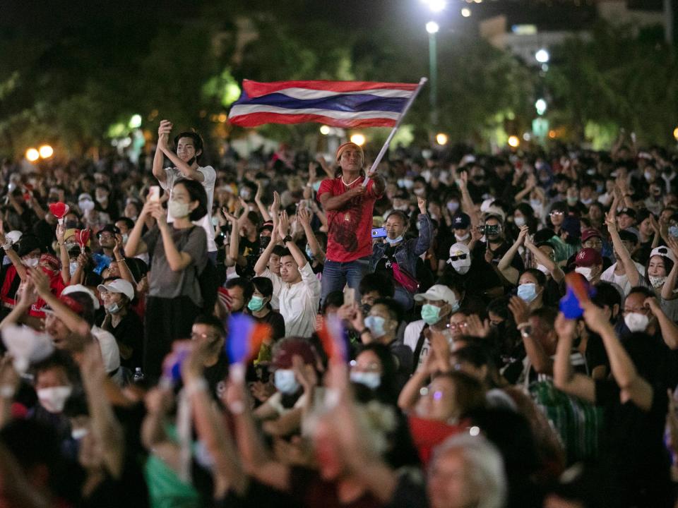 Pro-democracy protesters wave the national flag at the Sanam Luang field during a protest in Bangkok, Thailand (AP)