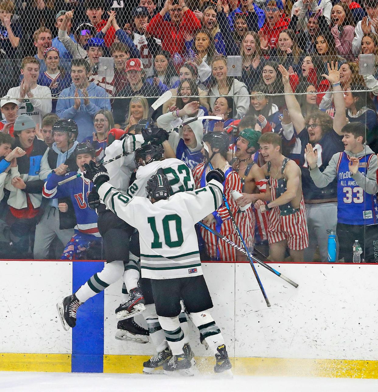 Dragons players show their fans a goal celebration in front of them.The Duxbury boys hockey team hosted Wakefield at The Bog in Kingston winning in a 4-0 shutout on Wednesday March 8, 2023 